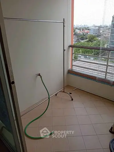 Spacious balcony with city view, perfect for outdoor relaxation and gardening.