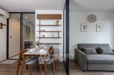 Modern living room with dining area, featuring stylish furniture and elegant decor in a cozy apartment setting.