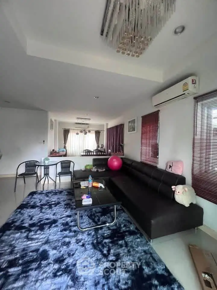 Spacious living room with modern decor and plush seating in a stylish home.