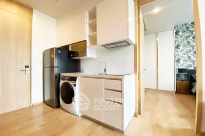 Modern compact kitchen with integrated appliances and sleek cabinetry