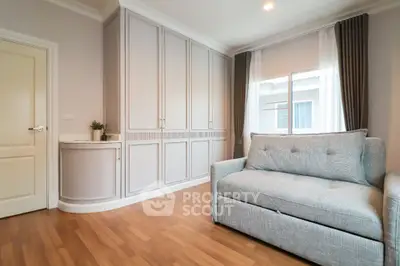 Cozy living room with elegant sofa and built-in storage cabinets