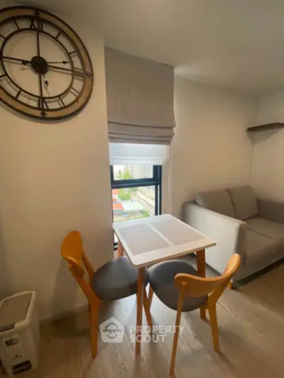 Cozy dining nook with modern decor and city view, perfect for urban living.