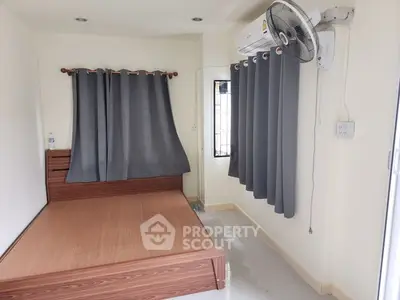 Cozy bedroom with modern air conditioning and stylish curtains