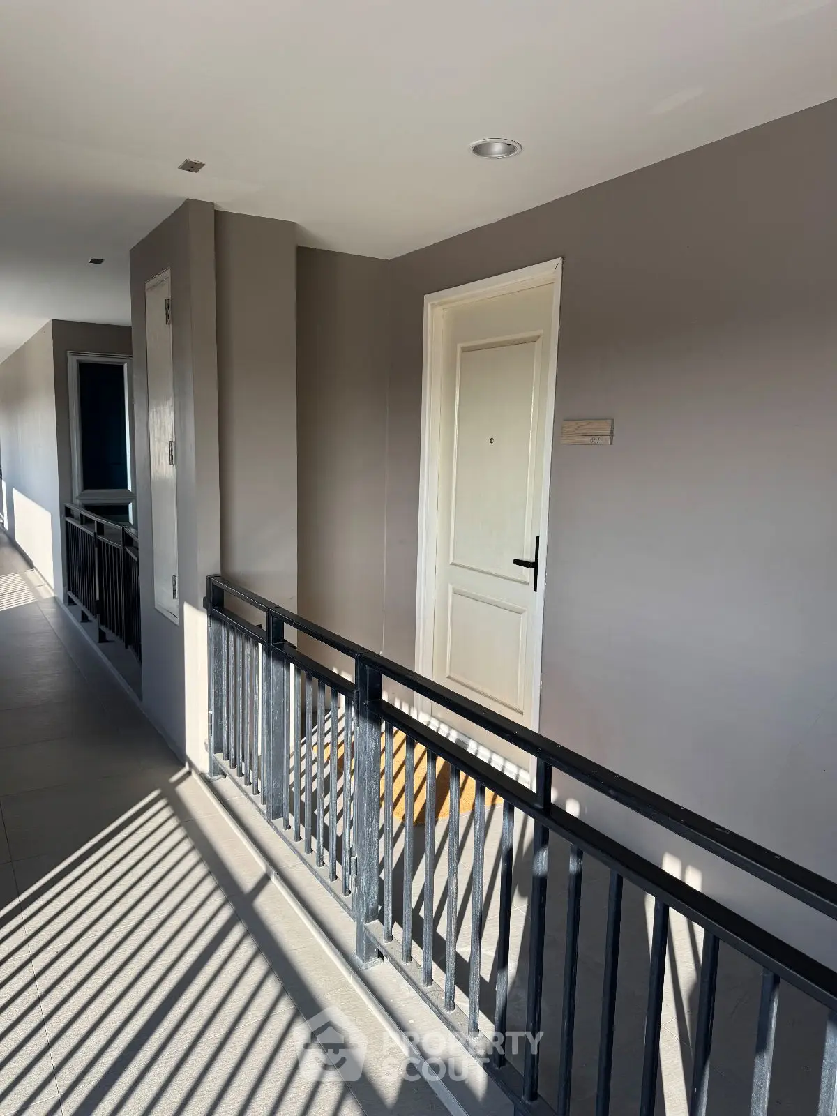 Modern apartment corridor with sleek design and natural lighting