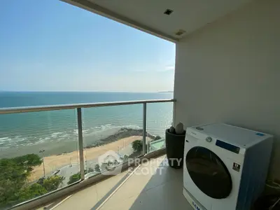 Stunning ocean view from balcony with modern washing machine setup