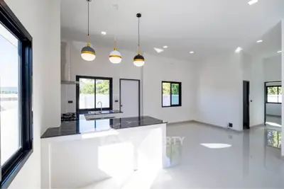 Modern open-plan kitchen with sleek design and ample natural light