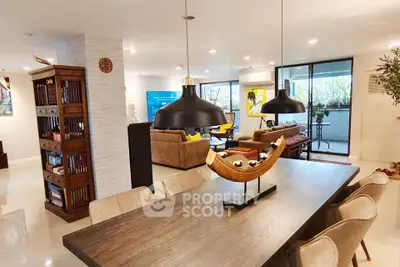 Spacious modern living room with elegant dining area and large balcony view.