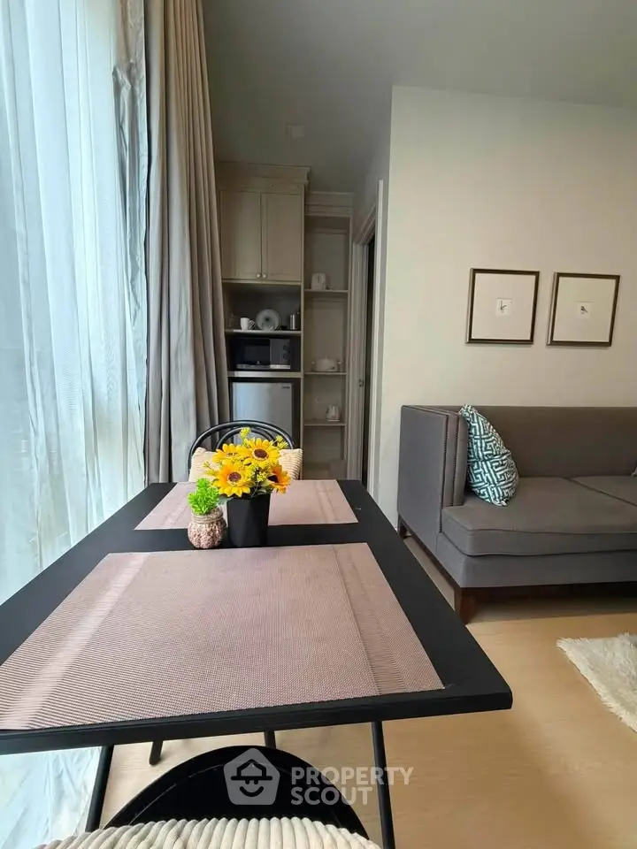 Charming living room with cozy seating and elegant dining area, perfect for modern living.