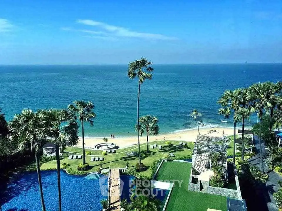 Stunning beachfront property with pool and lush gardens offering panoramic ocean views.