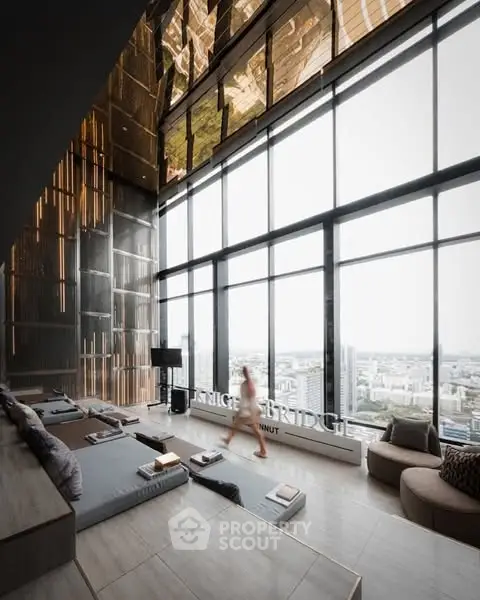 Luxurious high-rise living room with panoramic city views and modern decor.