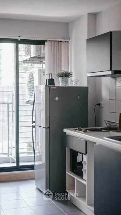 Modern kitchen with sleek appliances and balcony view