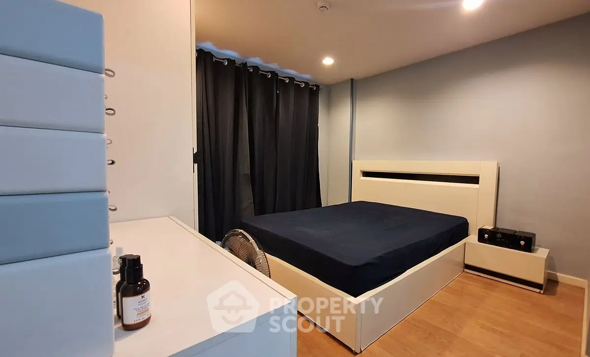 Modern bedroom with sleek design and cozy ambiance, featuring a stylish bed and contemporary furniture.