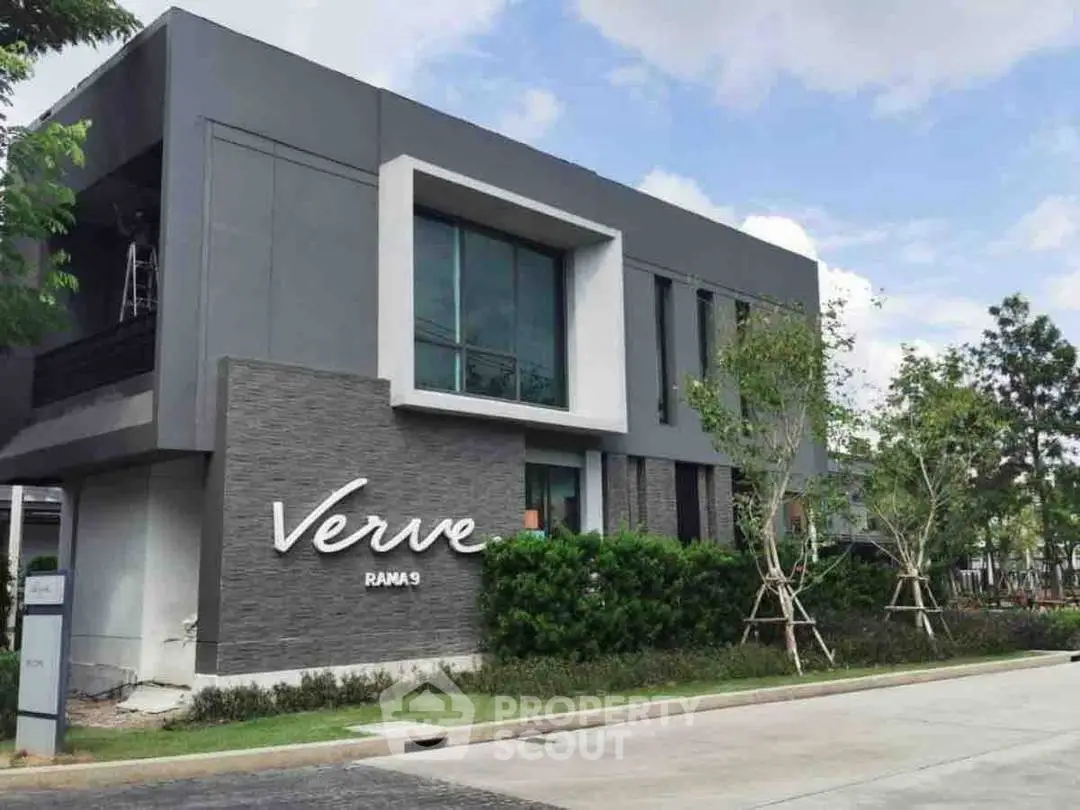 Modern architectural building with sleek design and lush greenery in Verve Rama 9.