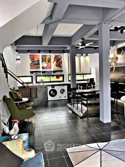 Modern open-concept living space with stylish decor and in-unit laundry facilities.