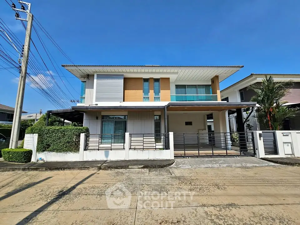 Modern two-story house with sleek design and spacious driveway in a serene neighborhood.