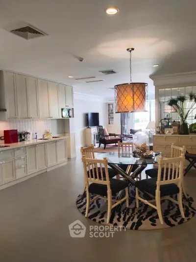 Spacious open-plan kitchen and dining area with elegant decor and modern appliances