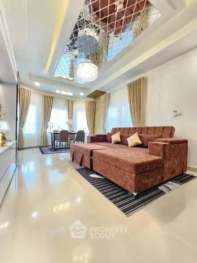 Luxurious living room with elegant chandelier and plush sofa in modern apartment