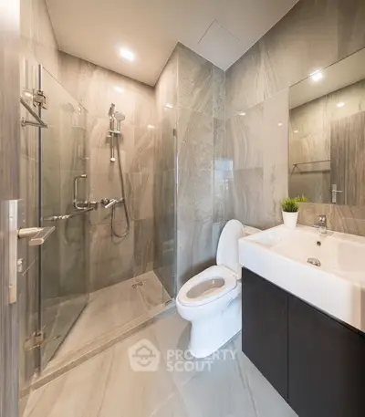 Luxurious modern bathroom with glass shower and sleek fixtures