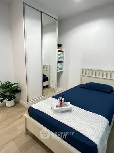 Cozy bedroom with modern decor and mirrored wardrobe