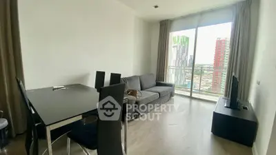 Modern living room with city view, sleek furniture, and large windows for natural light.