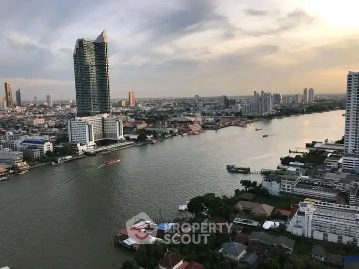 Stunning riverfront cityscape with modern high-rise buildings and serene water views at sunset.