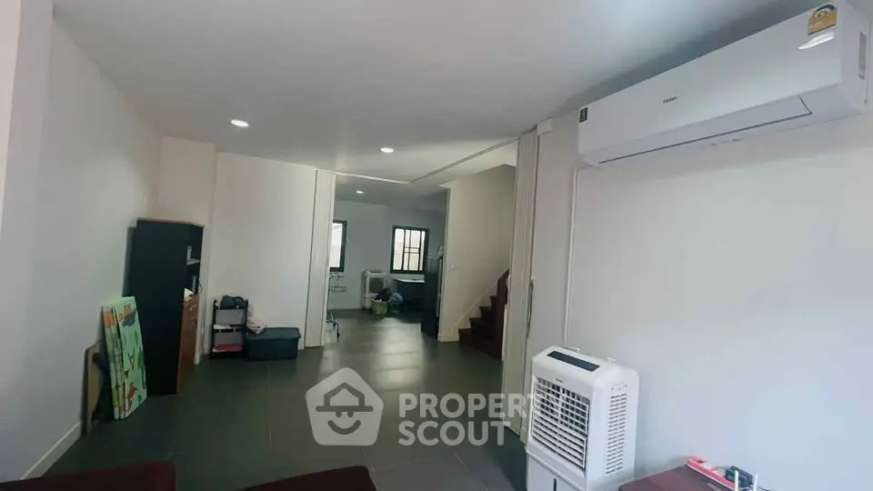 Spacious living room with modern air conditioning and sleek tile flooring