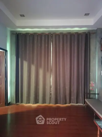 Cozy living room with elegant curtains and wooden flooring