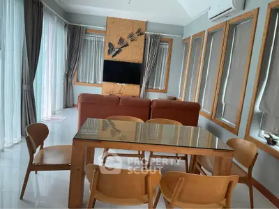 Spacious living room with modern furniture and large windows for natural light.