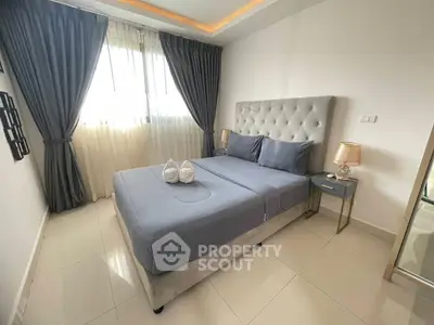 Elegant bedroom with plush bed, stylish curtains, and modern decor