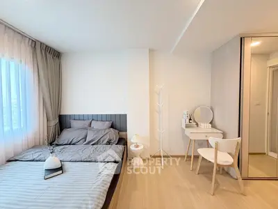 Modern bedroom with stylish decor and natural light