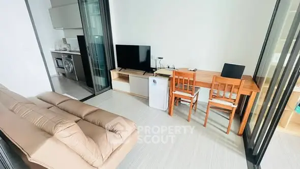 Modern living room with open kitchen and stylish furniture in a cozy apartment.