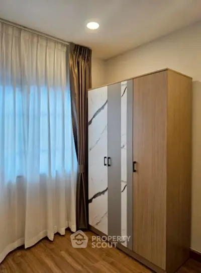 Modern bedroom with stylish wardrobe and elegant curtains