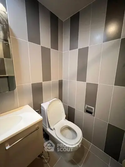Modern bathroom with sleek tile design and compact layout