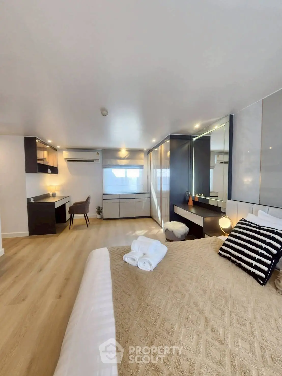 Spacious modern bedroom with elegant decor and natural light