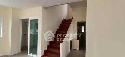 Spacious interior with wooden staircase and modern design, perfect for family living.