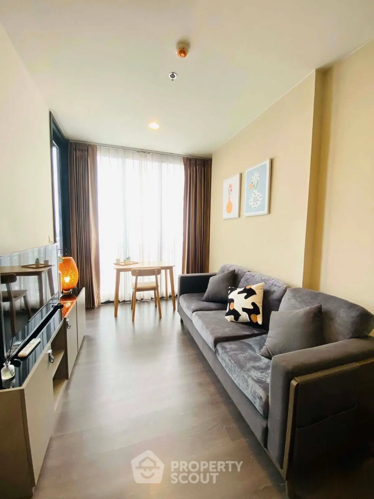 Modern living room with cozy sofa and natural light, perfect for relaxation.