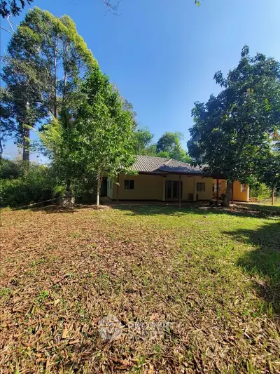 Charming countryside home surrounded by lush greenery and serene landscape.