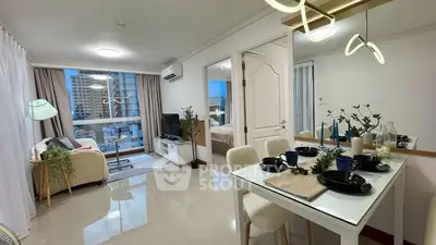 Modern open-plan living and dining area with stylish decor and city view.