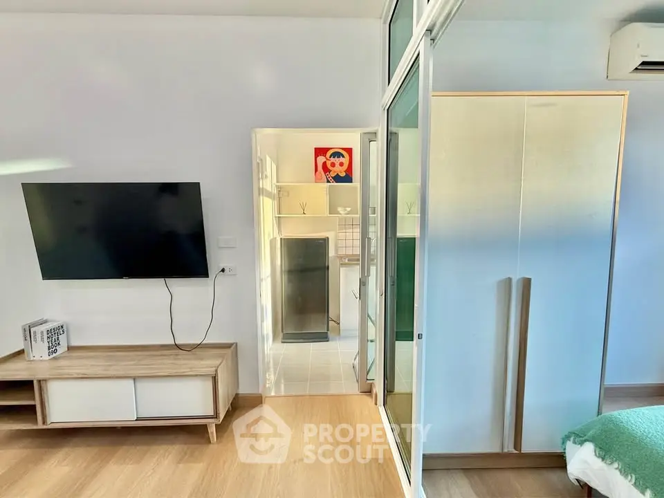 Modern living space with wall-mounted TV and sliding glass door