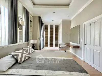 Luxurious bedroom with elegant decor and ample natural light, featuring a stylish bed and modern furnishings.