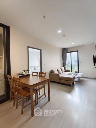 Modern living room with cozy sofa and dining area in open layout apartment
