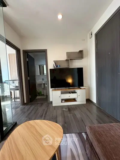 Modern living room with sleek TV setup and stylish wooden flooring