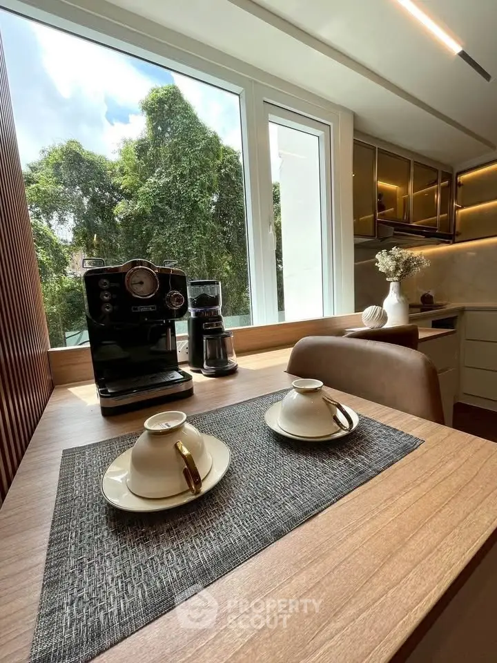 Modern kitchen with coffee machine and large window view