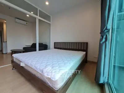 Modern bedroom with large window and minimalist design in urban apartment