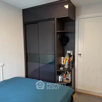 Modern bedroom with sleek wardrobe and cozy bed, perfect for urban living.