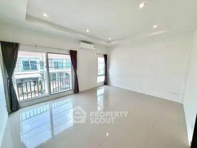 Spacious empty living room with large windows and modern lighting