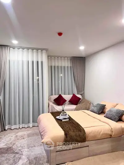 Elegant bedroom with modern decor and cozy ambiance, featuring a stylish bed and seating area.