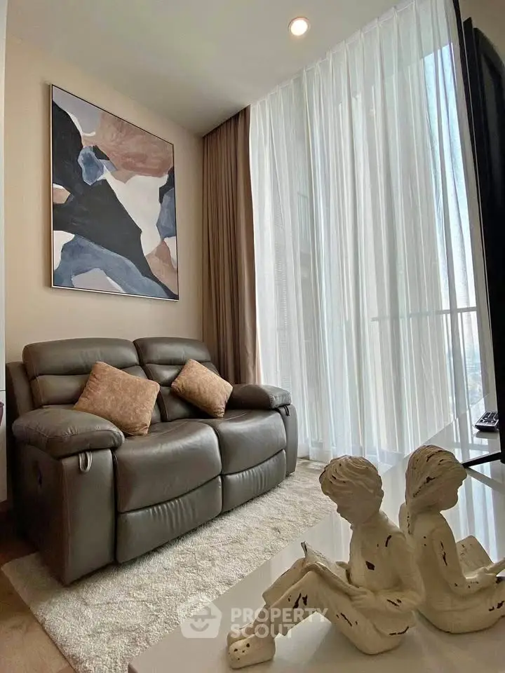 Stylish living room with modern decor and cozy seating in a bright apartment.