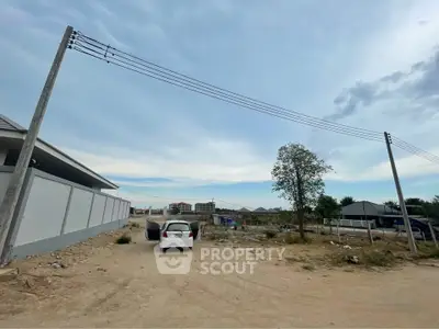 Expansive plot of land with potential for development, featuring open skies and a serene environment.