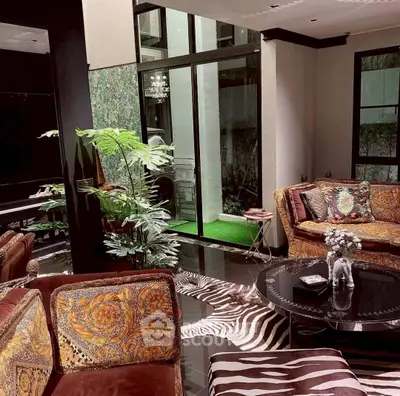 Luxurious living room with elegant decor and large windows offering natural light.